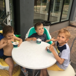 Egor tasting a coconut ice-cream with his friends in the cafe “33 penguins”, Sochi, 2019