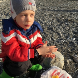 Enjoying juicy orange at the seaside, Sochi, 2019